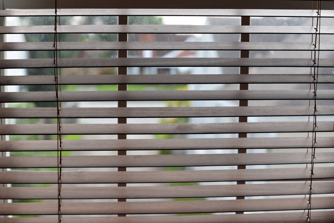 Wood blinds on a window facing the street at Blind & Shutter Gallery near Cape Coral, FL